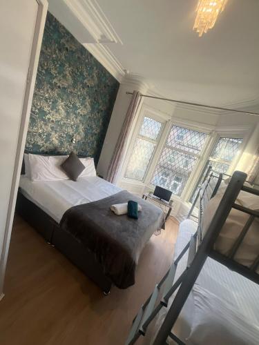 a bedroom with a bed and two windows at Mayfair hotel Blackpool city centre in Blackpool
