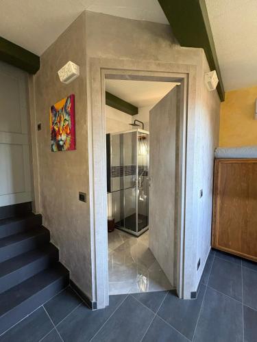 a hallway with stairs and a painting on the wall at Camera di Molly in Leivi