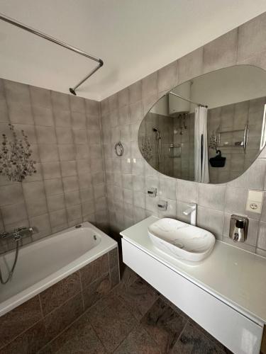 a bathroom with a tub and a toilet and a mirror at Villa Baldi -Apartmani Danny in Tar