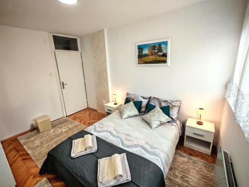 a bedroom with a bed with two towels on it at Apartman ANA in Pirot