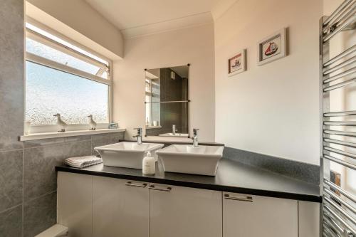 a bathroom with two sinks and a window at 3 Bed in Brixham oc-57892 in Brixham