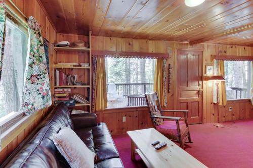 a living room with a couch and a table at Beth's Lakeside Cabin in McCall