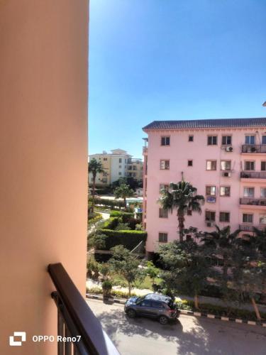 a view from a balcony of a building and a car at Building 211, Gulf 2, Apartment 403 in ‘Ezbet `Abd el-Ḥamîd