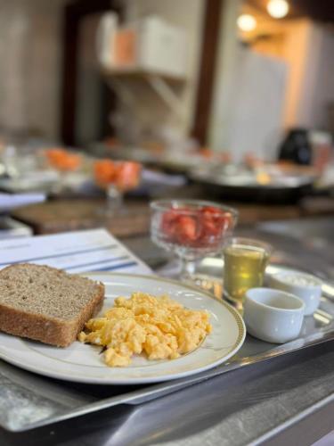 a plate of eggs and toast on a table at Spa Posse do Corpo in Araras Petropolis