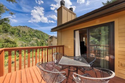 a patio with a table and chairs on a deck at Slope-Side Getaway Deck Pool Table Views in Boise