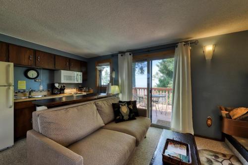 a living room with a couch and a kitchen at Slope-Side Getaway Deck Pool Table Views in Boise