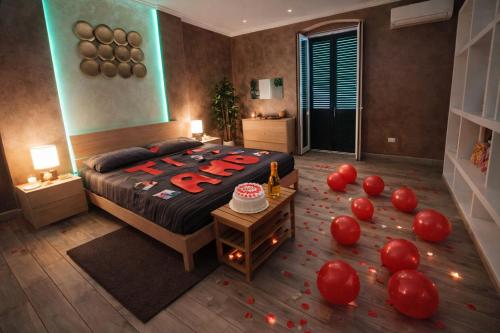 a bedroom with a bed with red balloons on the floor at Suite Natura Bed&Beauty Spa in Taranto