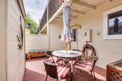 a patio with a table and chairs and an umbrella at Private Townhome - Mountain Views & 2 Baths in Boise