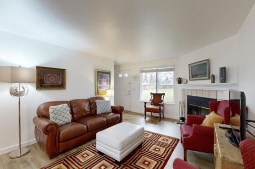 a living room with a leather couch and a fireplace at Private Townhome - Mountain Views & 2 Baths in Boise