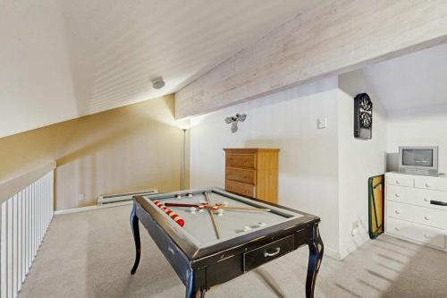 a room with a pool table in the middle of it at McCall Mountain Condo Pool Sauna Deck in McCall