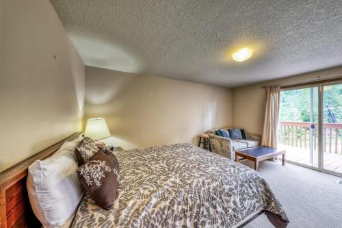 a bedroom with a bed and a large window at Mountain Retreat Slope Access 2 Decks in Boise