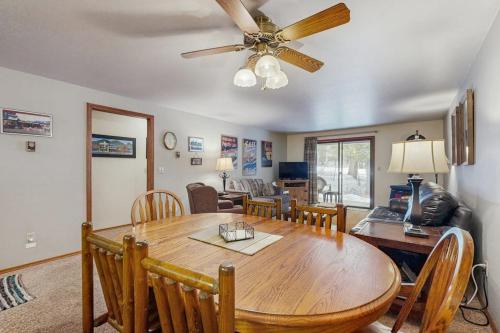 a dining room with a table and a ceiling fan at Golf Course Retreat - Pool Access Lake Views in McCall
