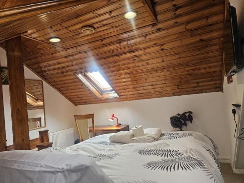 a bedroom with a bed with a wooden ceiling at Seraphic Homes Medway Kent in Gillingham