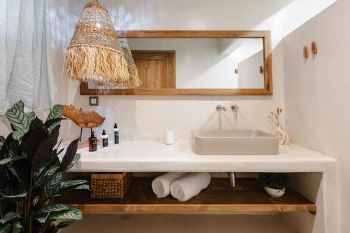 a bathroom with a sink and a mirror at Chic Elysium in Naxos Chora