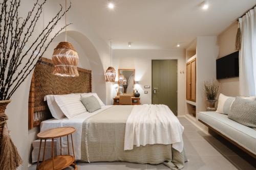 a bedroom with a large bed and a couch at Chic Elysium in Naxos Chora