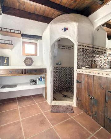 a bathroom with a sink and a shower at Casa MaLuMi - Historisches Stadthaus in Haría in Haría