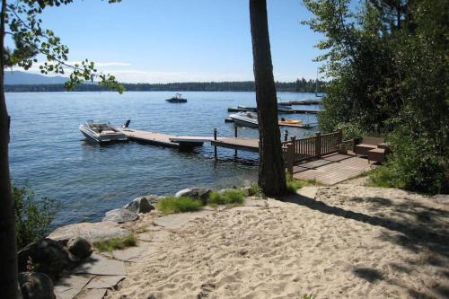 a dock on a lake with boats in the water at McCall Lakehouse Private Dock Beach & Grill in McCall