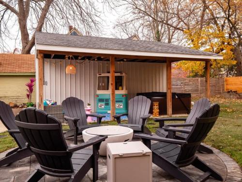 a group of chairs sitting on a patio with a gazebo at PoolTable - Hot Tub - FirePit - Games - Bunk Slide - Wet Bar in Akron