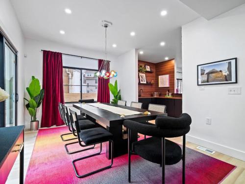 a dining room with a black table and black chairs at PoolTable - Hot Tub - FirePit - Games - Bunk Slide - Wet Bar in Akron