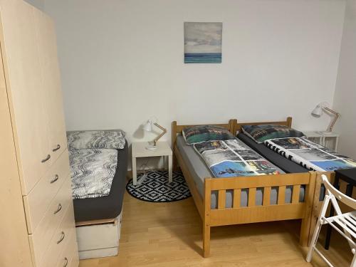 a bedroom with two beds and a bunk bed at Gästehaus JaWo in Neuruppersdorf