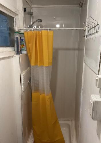 a shower curtain is hanging in a bathroom at Refugio Jemmy Button in Puerto Williams