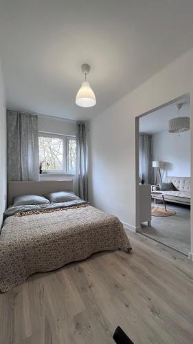 a bedroom with a bed and a large mirror at Silesia Park Bytom 24H Park Miejski Centrum in Bytom