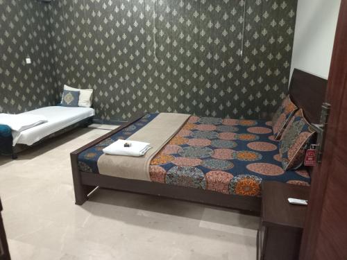 a bedroom with two beds in a room at The Norvane G-13 in Islamabad