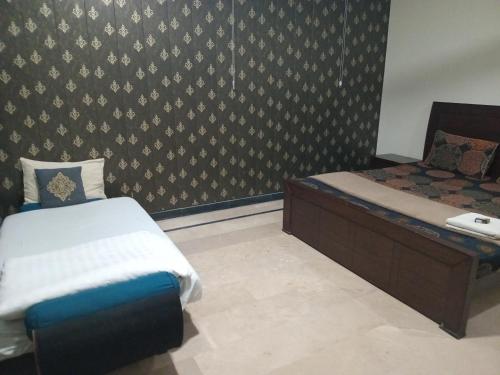 a bedroom with a bed and a wall at The Norvane G-13 in Islamabad