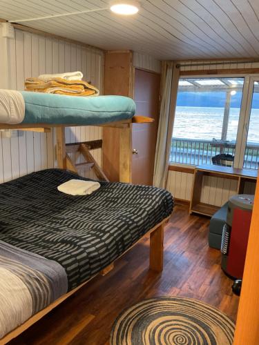 a bedroom with bunk beds on a boat at Refugio Jemmy Button in Puerto Williams