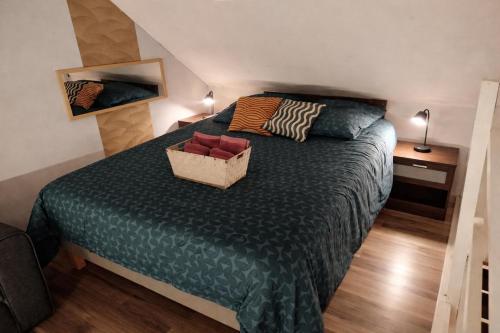 a bedroom with a bed with a basket on it at le petit cosy terrasse et spa in Petersbach