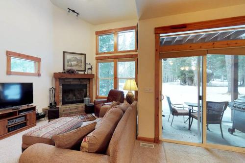 a living room with a couch and a fireplace at McCall Golf Condo - Pool Courts & Patio in McCall