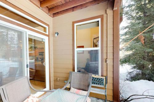 a porch with a chair and a window on a house at McCall Golf Condo - Pool Courts & Patio in McCall