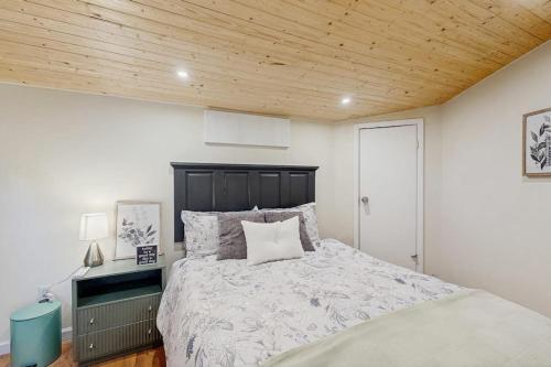 a bedroom with a bed and a wooden ceiling at The Treehouse at Banner Elk in Banner Elk