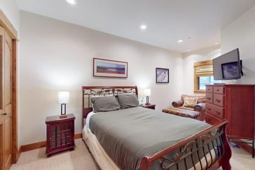 a bedroom with a bed and a dresser and a chair at Big Sky Bliss in Big Sky