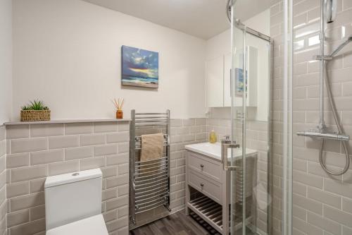 a bathroom with a shower and a toilet and a sink at 3 Bed in Lochearnhead oc-c33641 in Lochearnhead
