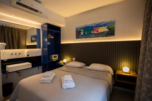 a hotel room with two beds with towels on them at America Del Sur Hostel Buenos Aires in Buenos Aires