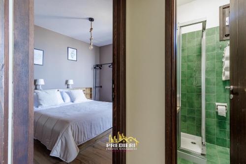 a bedroom with a bed and a glass shower at Sest0la Centro Loft con Vista sul Paesaggio in Sestola