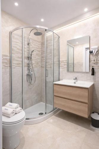 a bathroom with a shower and a toilet and a sink at Appio Rooms Haven in Rome