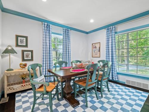a dining room with a table and chairs at Renovated Cottage - Game Room - Fire Pit - Sleeps 8 in Moreland Hills