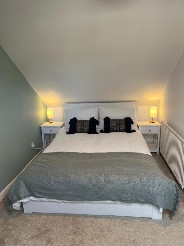 a bedroom with a white bed with two night stands at The Ferry Loft Montrose in Montrose