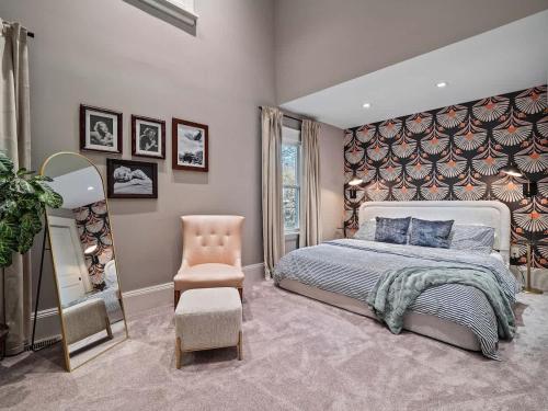 a bedroom with a large bed and a chair at Cleveland Escape - Hot Tub - Karaoke Machine - Sleeps 12 in Cleveland