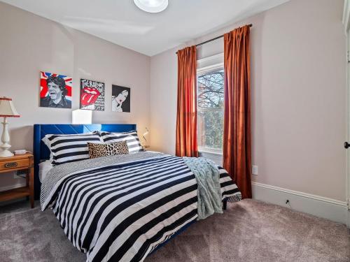 a bedroom with a bed and a window at Cleveland Escape - Hot Tub - Karaoke Machine - Sleeps 12 in Cleveland