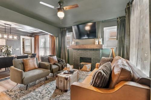 a living room with a couch and a fireplace at The Paper Plane Pool - Sauna - Poker Room - Sleeps 8 in Dayton