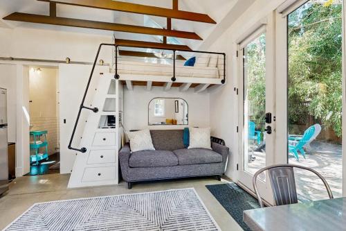 a living room with a couch and a loft bed at Charming Tiny Home in Boise's North End in Boise