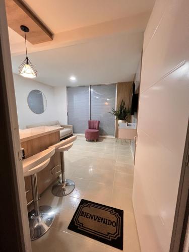 a hotel room with a sign on the floor at Ruby Suites I Apto en Valledupar I Lujo y Confort I Aire en todas las habitaciones in Valledupar