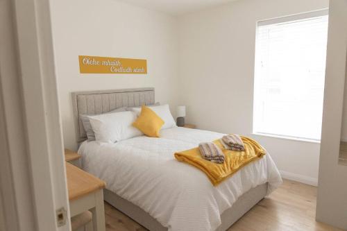 a bedroom with a bed with two towels on it at Derry City Centre 1 & 2 Bedroom Modern Apartments in Derry Londonderry