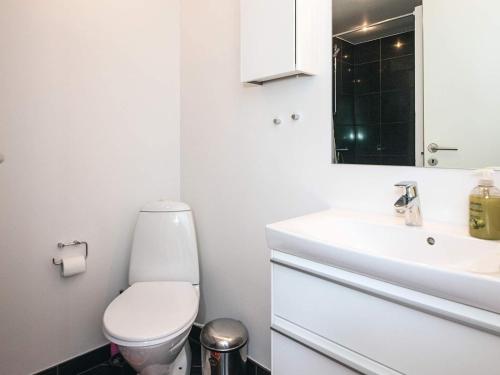 a white bathroom with a toilet and a sink at 4 person holiday home in Hejls-By Traum in Hejls