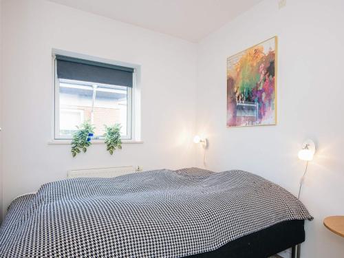 a white bedroom with a bed and a window at 4 person holiday home in Hejls-By Traum in Hejls