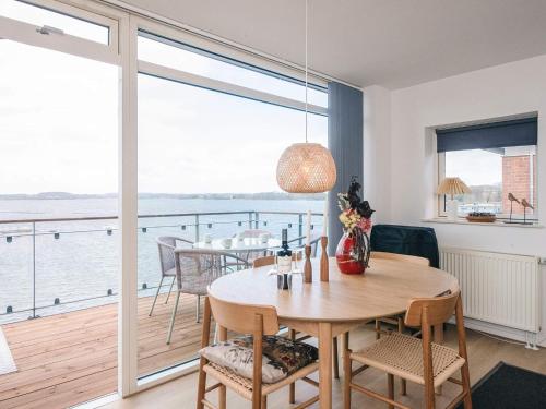 a dining room with a table and a balcony at 4 person holiday home in Hejls-By Traum in Hejls