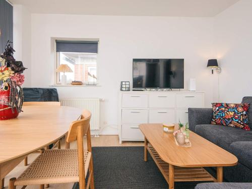 a living room with a table and a couch at 4 person holiday home in Hejls-By Traum in Hejls
